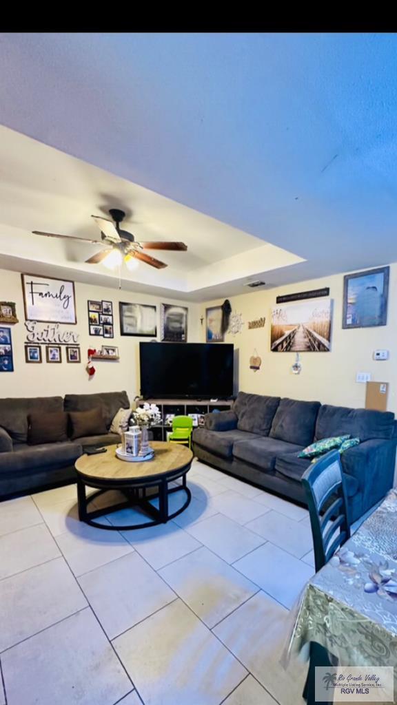 2 Woodstone Dr, Brownsville, TX 78526 - living area with a raised ceiling, ceiling fan, and tile patterned flooring