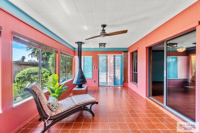 sunroom / solarium featuring a wealth of natural light and ceiling fan