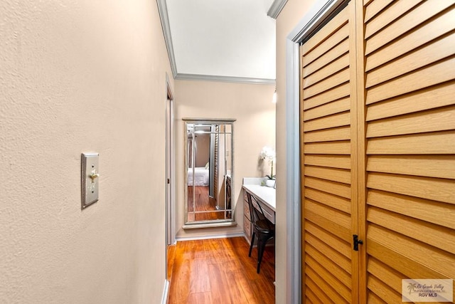 hall featuring ornamental molding and hardwood / wood-style flooring