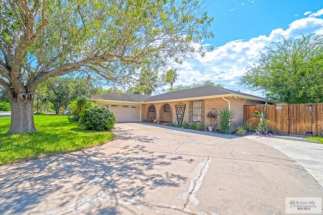 ranch-style house featuring a garage and a front lawn