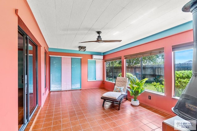 sunroom / solarium featuring ceiling fan and a wall unit AC