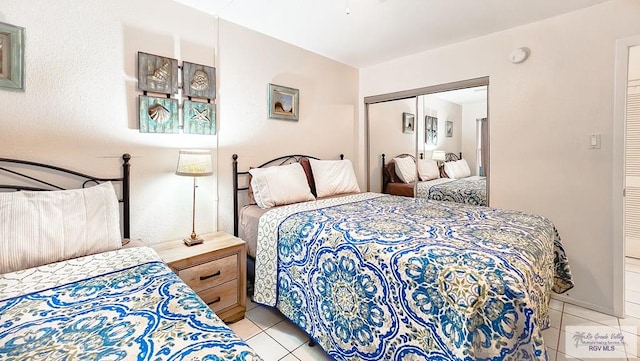 tiled bedroom featuring a closet