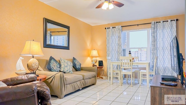 living room with ceiling fan and light tile patterned flooring