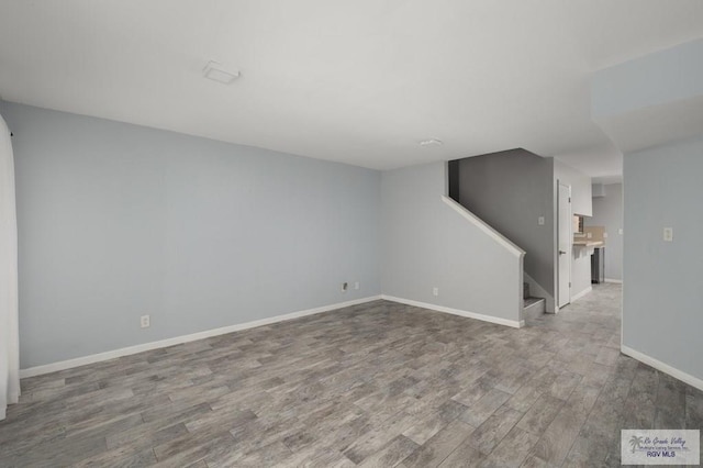 interior space featuring stairway, baseboards, and wood finished floors