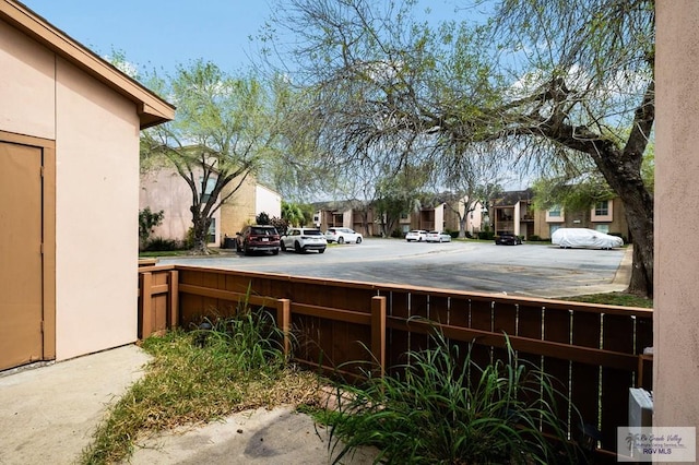 view of yard featuring a residential view and fence