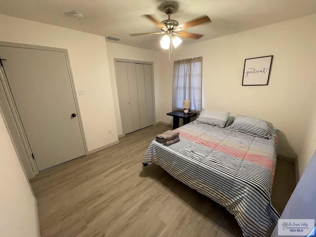 bedroom featuring light wood-type flooring, ceiling fan, and a closet