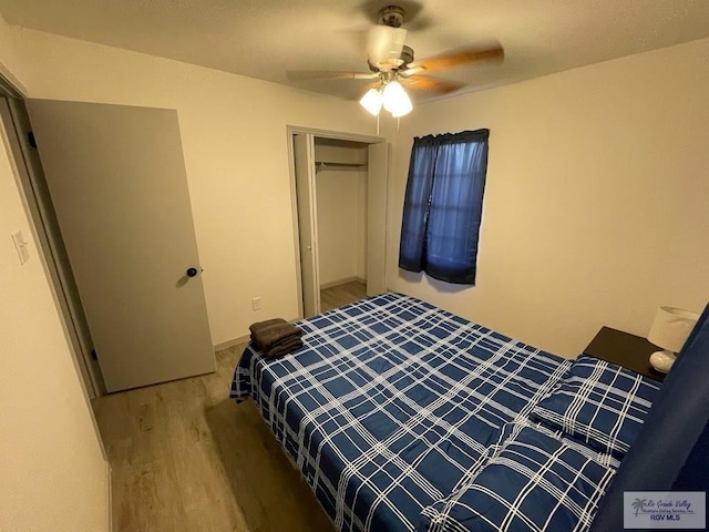 bedroom with hardwood / wood-style floors, a closet, and ceiling fan