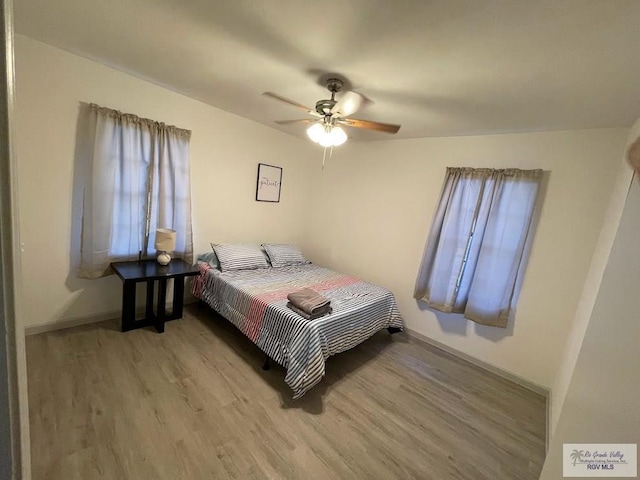 bedroom with ceiling fan and light hardwood / wood-style flooring