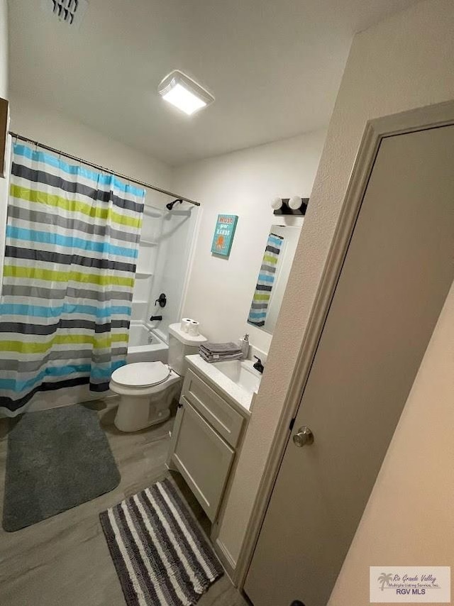 full bathroom featuring hardwood / wood-style flooring, vanity, toilet, and shower / bath combo