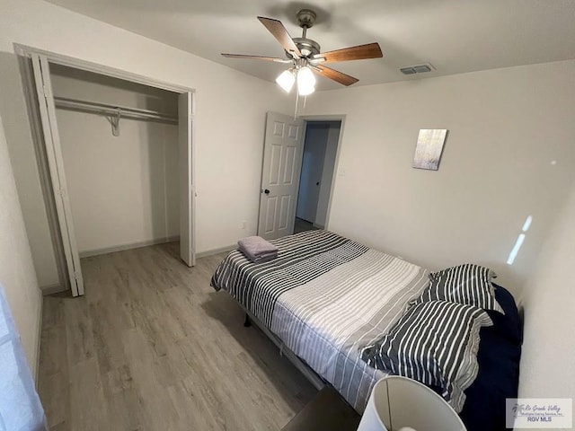 bedroom featuring light hardwood / wood-style flooring, a closet, and ceiling fan