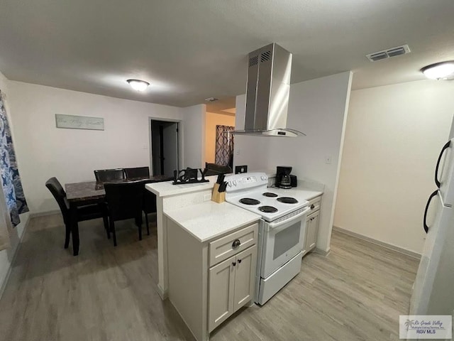 kitchen featuring island exhaust hood, light hardwood / wood-style flooring, kitchen peninsula, and white range with electric cooktop