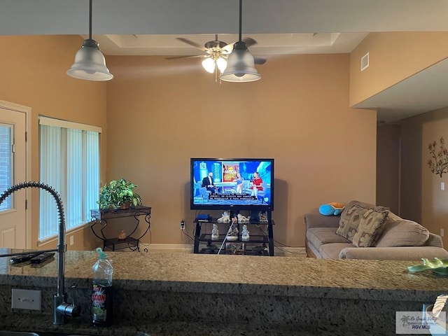 living room with ceiling fan and sink