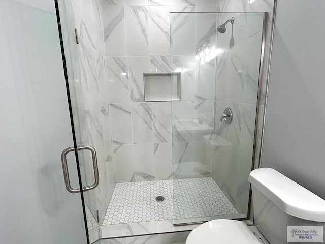 bathroom featuring an enclosed shower and toilet