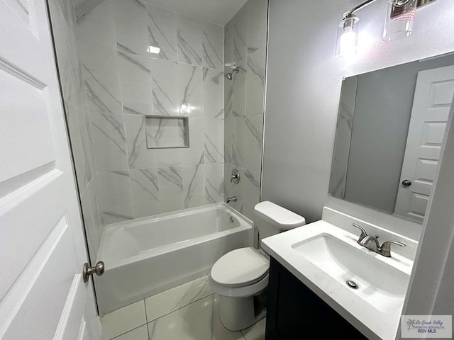 full bathroom featuring tiled shower / bath, vanity, and toilet