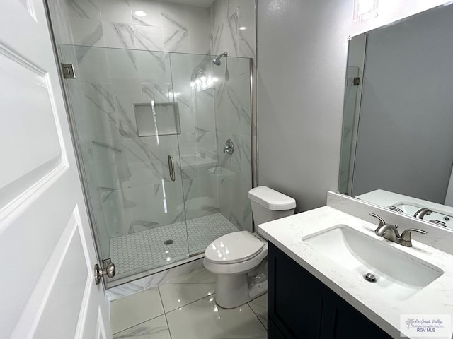 bathroom featuring vanity, an enclosed shower, and toilet