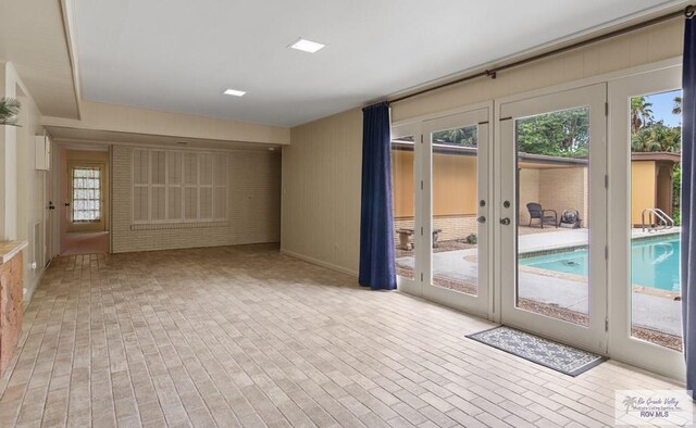 509 Lake Dr, Harlingen, TX 78550 - unfurnished room with brick patterned flooring, french doors, and healthy amount of natural light
