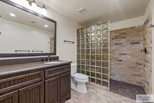 509 Lake Dr, Harlingen, TX 78550 - bathroom featuring a walk in shower, vanity, and recessed lighting
