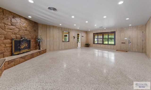 509 Lake Dr, Harlingen, TX 78550 - unfurnished living room with speckled floor, recessed lighting, and a stone fireplace
