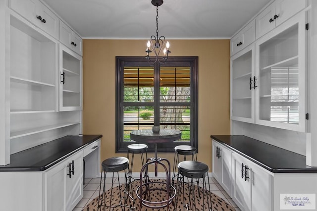 509 Lake Dr, Harlingen, TX 78550 - dining space featuring light tile patterned flooring and a chandelier