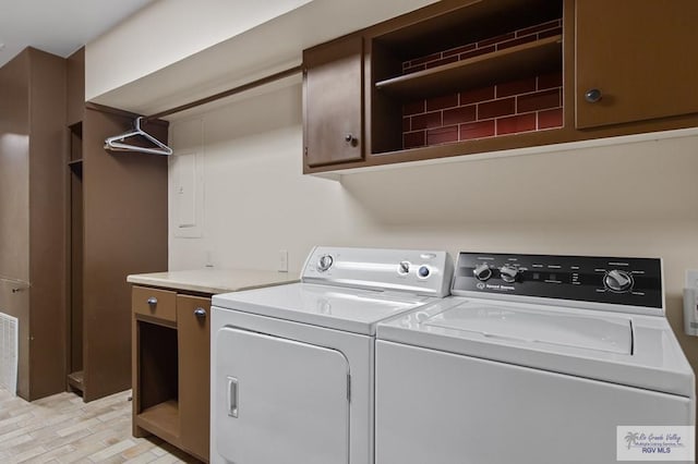 509 Lake Dr, Harlingen, TX 78550 - washroom with washer and dryer and cabinet space
