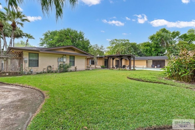 509 Lake Dr, Harlingen, TX 78550 - view of front of home with a swimming pool and brick siding