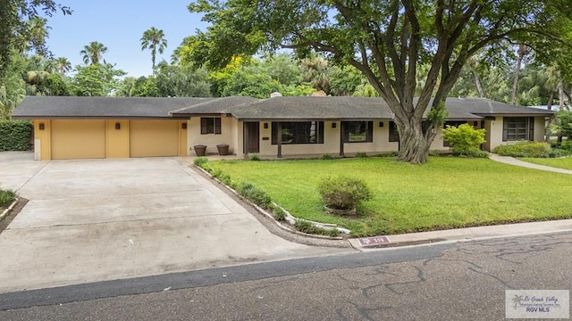 509 Lake Dr, Harlingen, TX 78550 - ranch-style house with driveway, an attached garage, and a front lawn