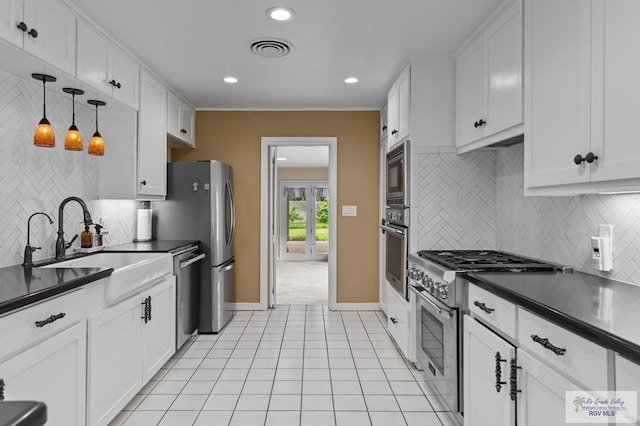 509 Lake Dr, Harlingen, TX 78550 - kitchen featuring appliances with stainless steel finishes, dark countertops, backsplash, white cabinetry, and recessed lighting