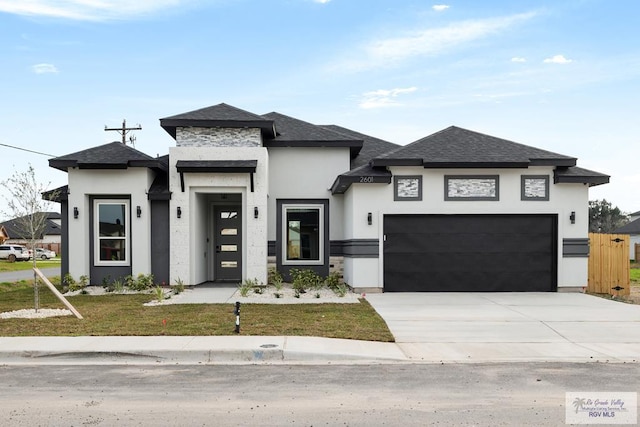 prairie-style home featuring driveway, a shingled roof, a garage, and stucco siding