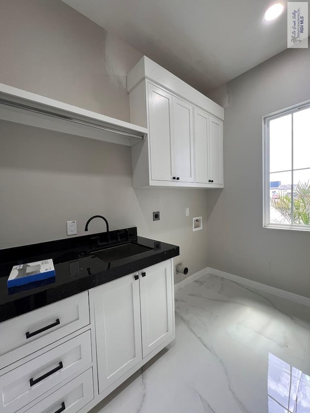 laundry area with hookup for an electric dryer, washer hookup, baseboards, marble finish floor, and cabinet space