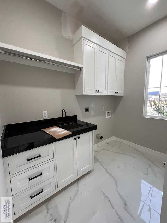 washroom featuring marble finish floor, hookup for a washing machine, cabinet space, electric dryer hookup, and baseboards