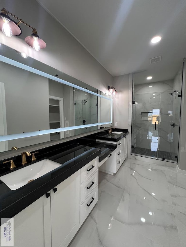 bathroom featuring a stall shower, marble finish floor, visible vents, and vanity