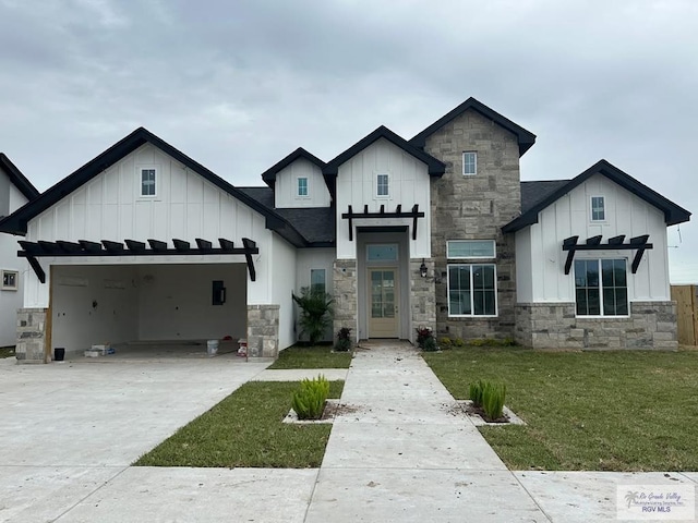 modern farmhouse featuring a shingled roof, concrete driveway, an attached garage, board and batten siding, and a front yard