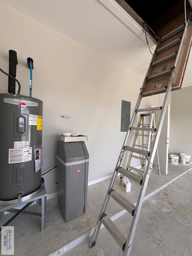 interior space with a garage, electric panel, and electric water heater