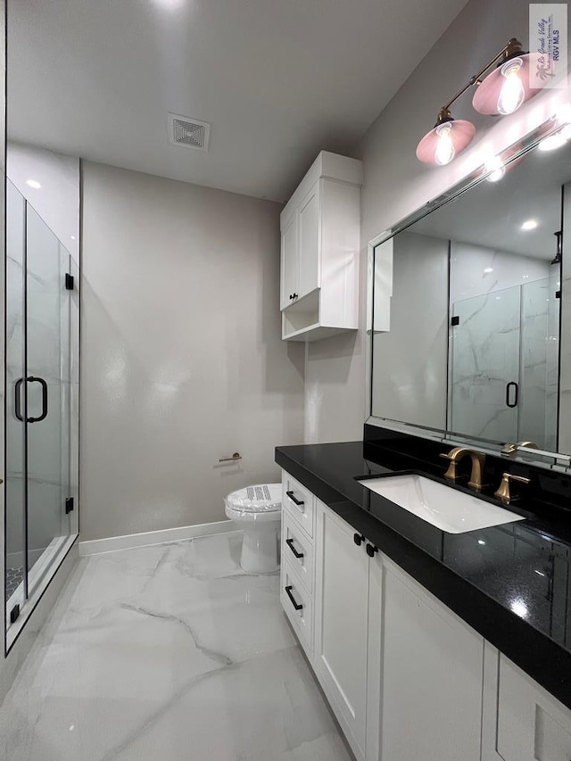 bathroom featuring a marble finish shower, visible vents, toilet, marble finish floor, and vanity