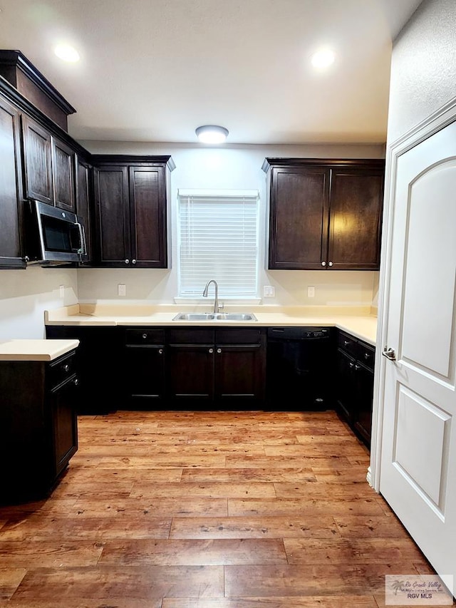 kitchen with dishwasher, dark brown cabinetry, light hardwood / wood-style flooring, and sink