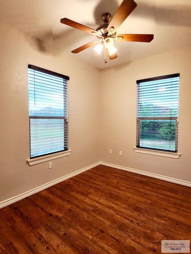 unfurnished room with dark hardwood / wood-style floors, ceiling fan, and a wealth of natural light