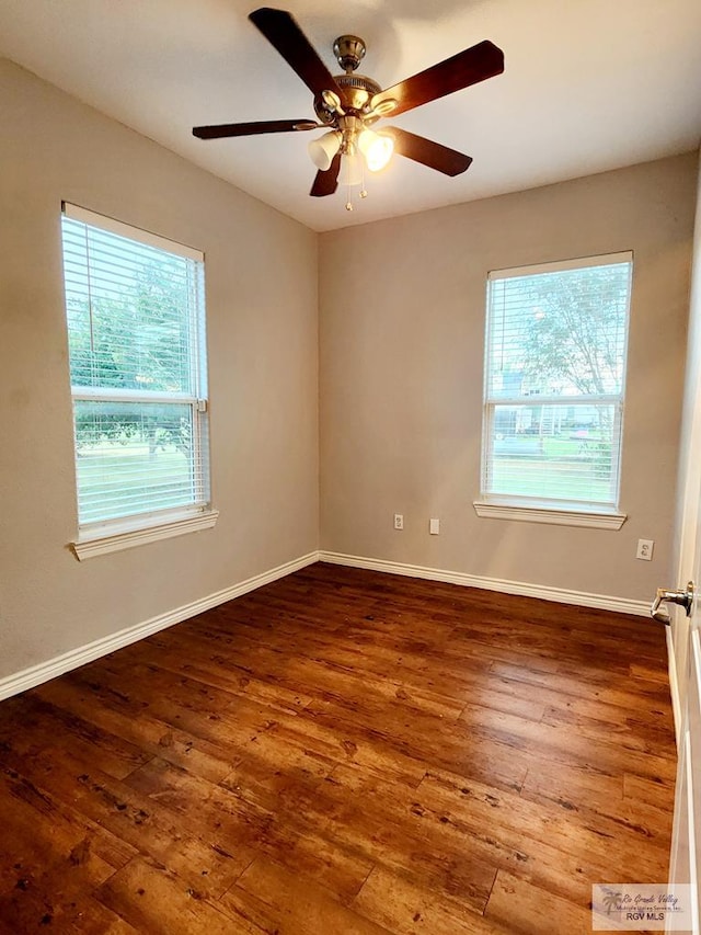 spare room with hardwood / wood-style floors, ceiling fan, and a wealth of natural light