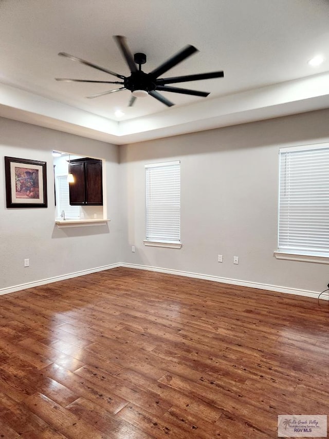 unfurnished room featuring ceiling fan and dark hardwood / wood-style flooring