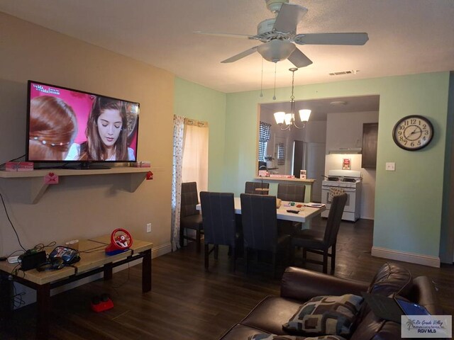 living room featuring dark hardwood / wood-style flooring and ceiling fan with notable chandelier