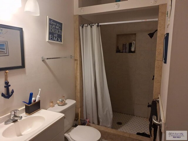 bathroom with vanity, toilet, and curtained shower