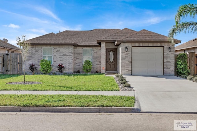 view of front of home with a garage and a front lawn