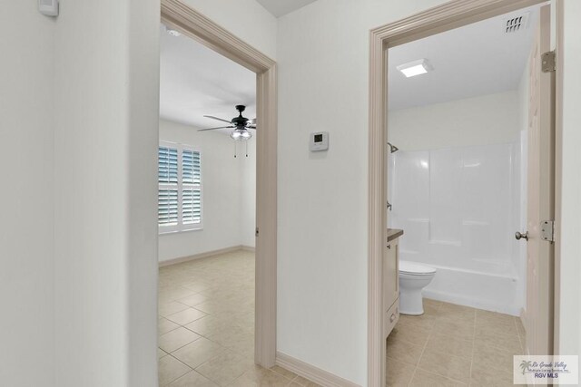 corridor featuring light tile patterned floors