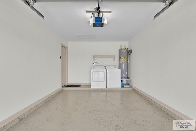 garage with independent washer and dryer, a garage door opener, and water heater