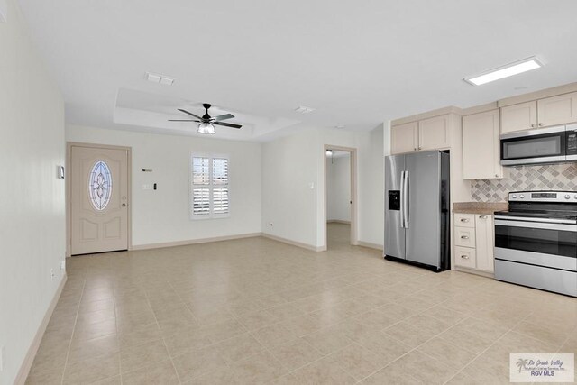 kitchen with ceiling fan, light tile patterned flooring, decorative backsplash, and stainless steel appliances