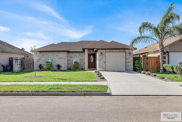 view of front of home featuring a garage and a front lawn