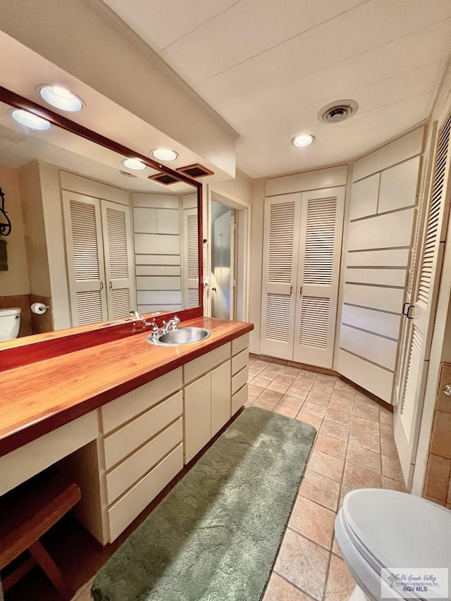 1914 S Parkwood Dr, Harlingen, TX 78550 - bathroom featuring a closet, vanity, recessed lighting, and tile patterned floors