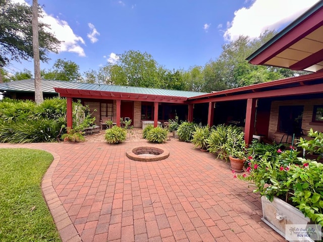 1914 S Parkwood Dr, Harlingen, TX 78550 - view of patio / terrace with a fire pit