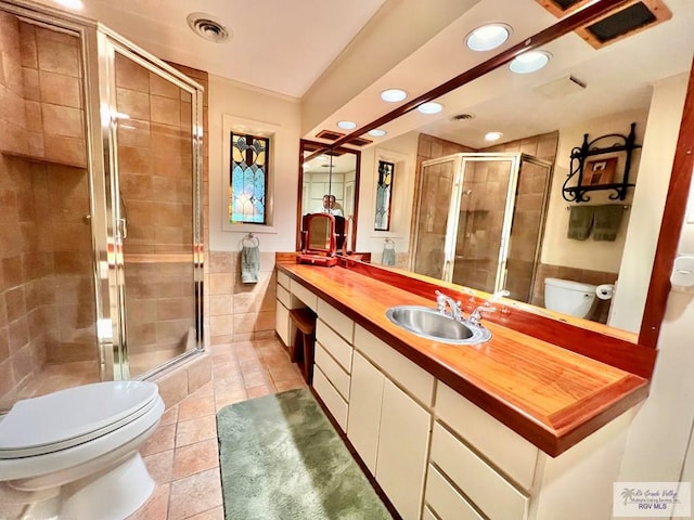 1914 S Parkwood Dr, Harlingen, TX 78550 - bathroom with double vanity, recessed lighting, tile patterned flooring, and a shower stall