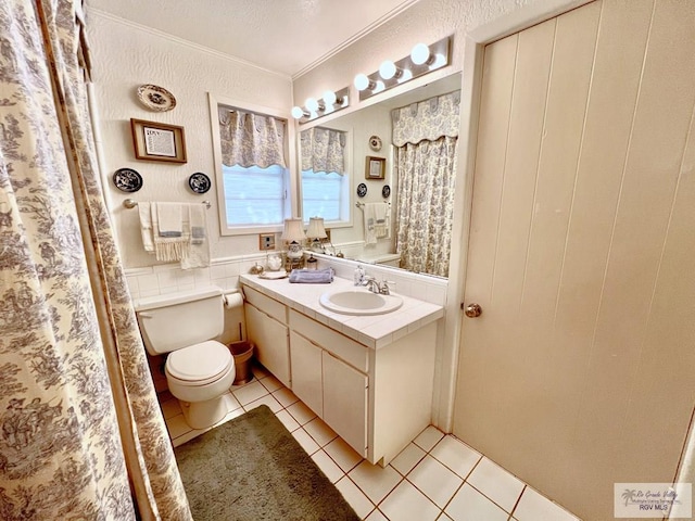 1914 S Parkwood Dr, Harlingen, TX 78550 - full bath featuring tile patterned floors, vanity, crown molding, and curtained shower