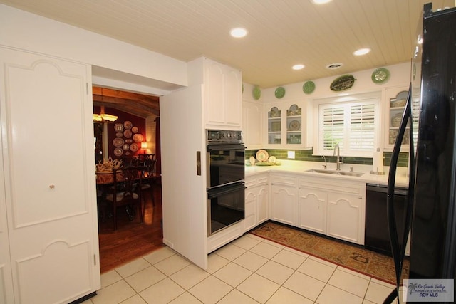 1914 S Parkwood Dr, Harlingen, TX 78550 - kitchen with black appliances, recessed lighting, white cabinets, light countertops, and backsplash